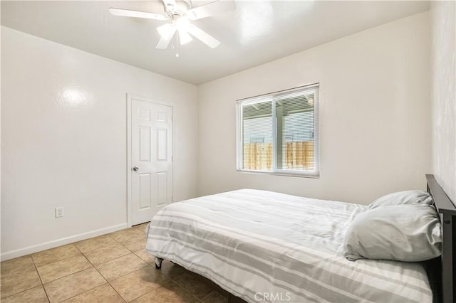 bedroom with light tile patterned floors, baseboards, and ceiling fan