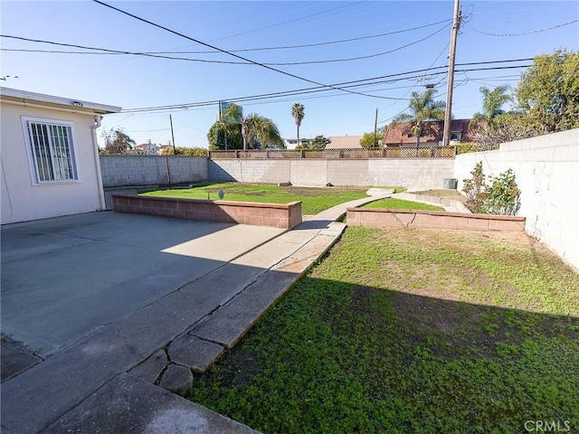 view of yard featuring a fenced backyard and a patio area