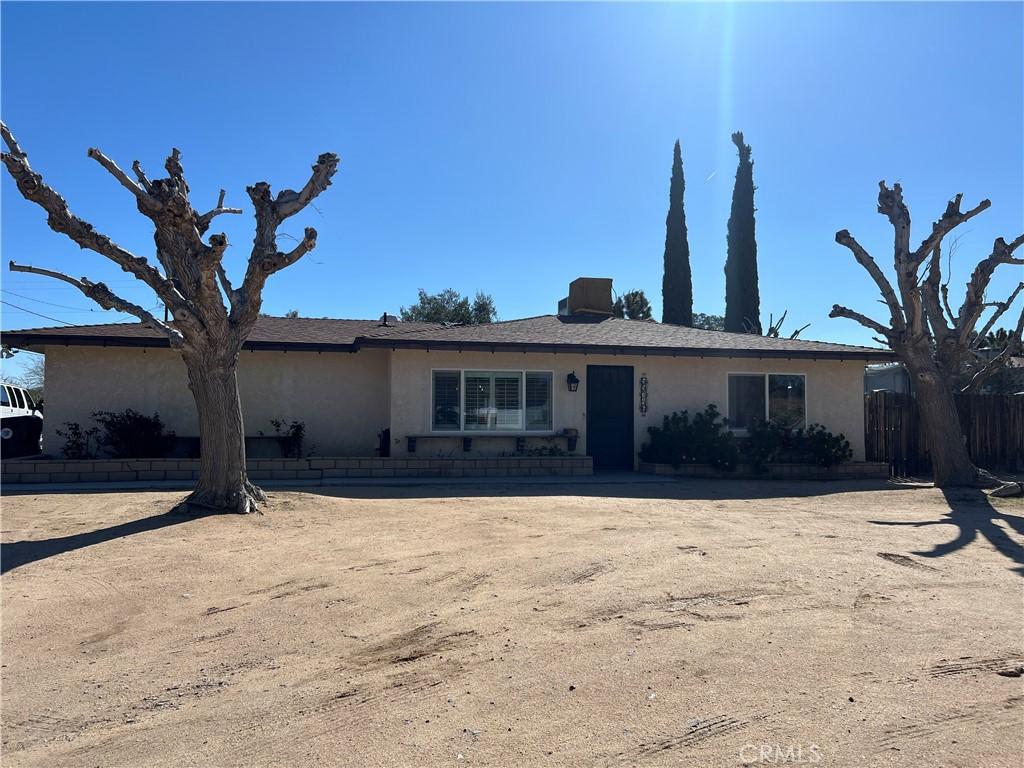 single story home featuring fence and stucco siding