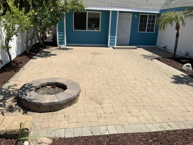 view of patio / terrace with an outdoor fire pit and fence