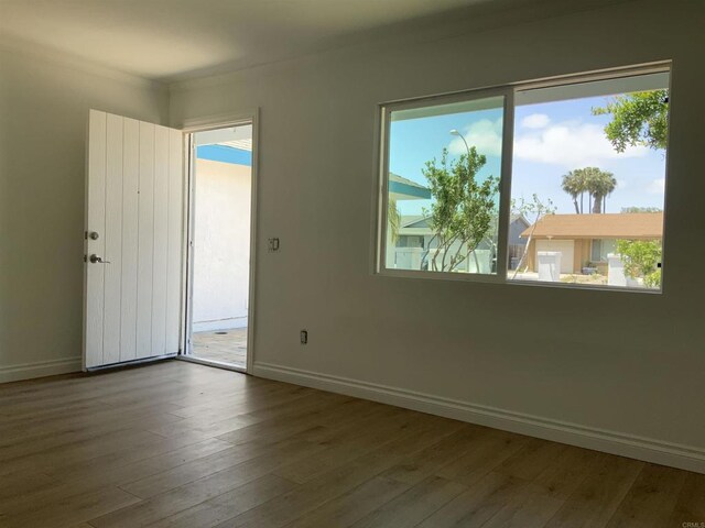 unfurnished room featuring baseboards and hardwood / wood-style floors