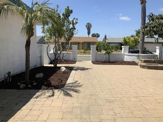 exterior space with a fenced front yard and stucco siding