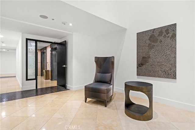 sitting room featuring tile patterned floors, recessed lighting, and baseboards