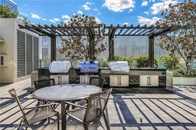 view of patio / terrace featuring grilling area, exterior kitchen, and a pergola