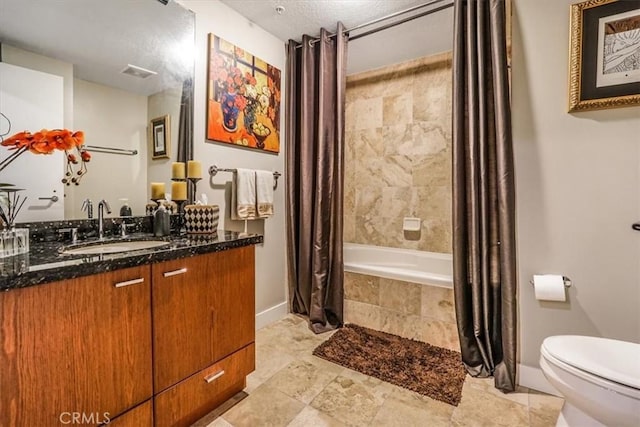 full bathroom featuring visible vents, baseboards, toilet, vanity, and tiled shower / bath