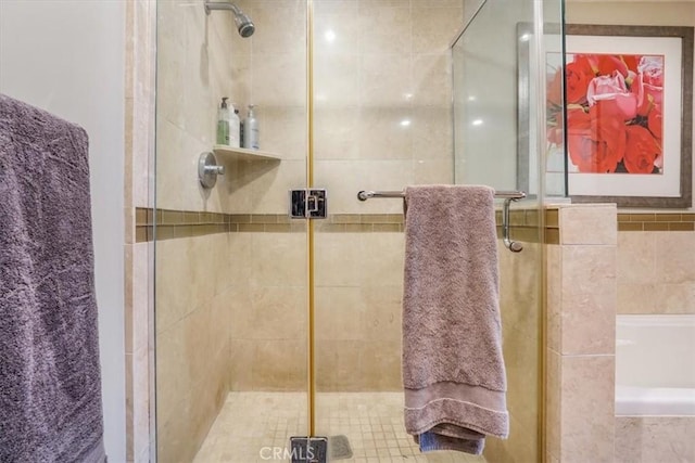 full bath featuring a shower stall and a bathtub