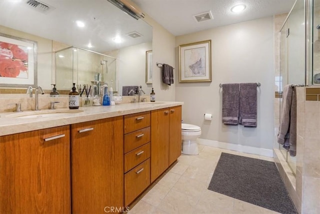 full bathroom featuring a stall shower, toilet, visible vents, and a sink