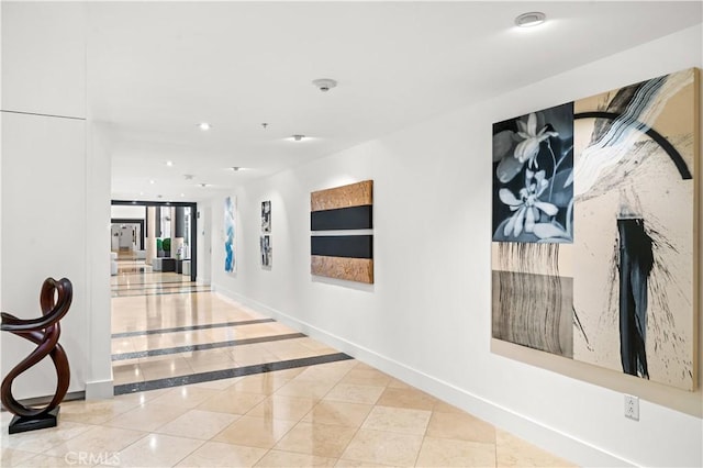 hallway with tile patterned flooring, recessed lighting, and baseboards