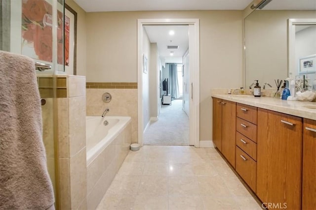 full bath featuring tile patterned flooring, baseboards, a garden tub, double vanity, and a shower with shower door