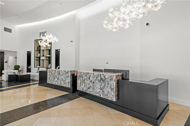 reception area featuring a notable chandelier and visible vents