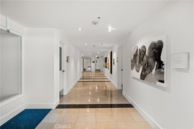 corridor with recessed lighting, baseboards, and tile patterned floors