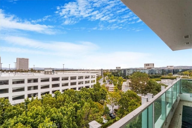 balcony with visible vents and a view of city