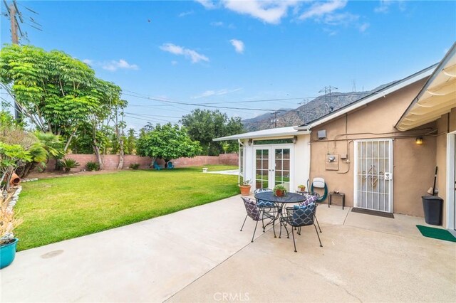 view of patio featuring french doors and a fenced backyard