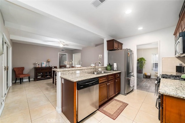 kitchen with light tile patterned floors, a ceiling fan, visible vents, a sink, and appliances with stainless steel finishes