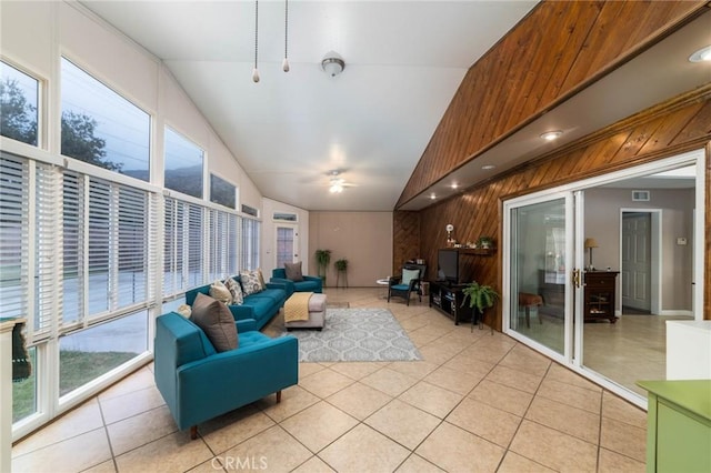 sunroom / solarium featuring visible vents, a healthy amount of sunlight, lofted ceiling, and ceiling fan