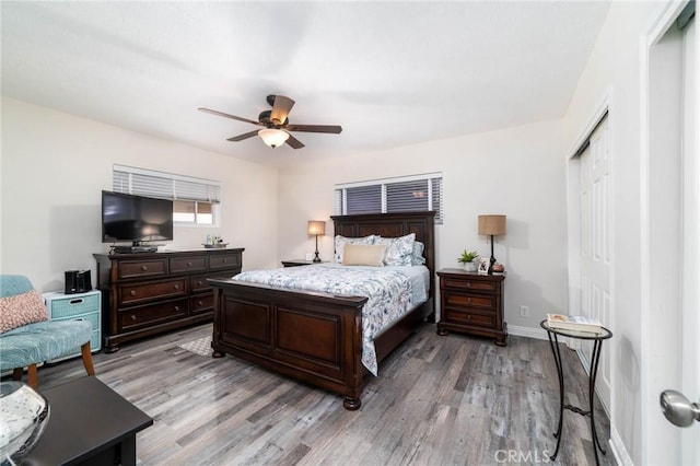 bedroom with a ceiling fan, light wood-style floors, a closet, and baseboards