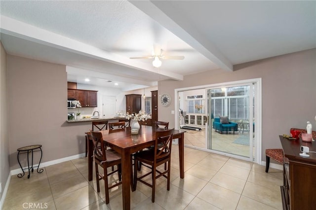 dining area featuring beamed ceiling, baseboards, light tile patterned flooring, and a ceiling fan