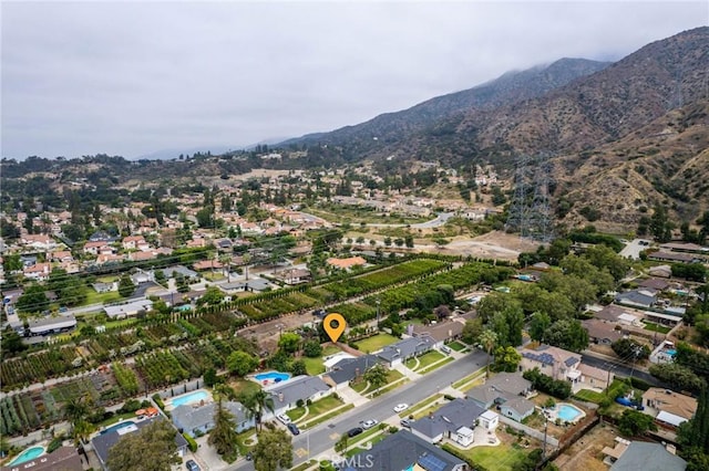 birds eye view of property with a mountain view