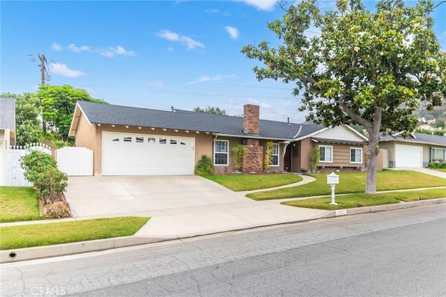 ranch-style house with fence, concrete driveway, a front yard, a chimney, and a garage