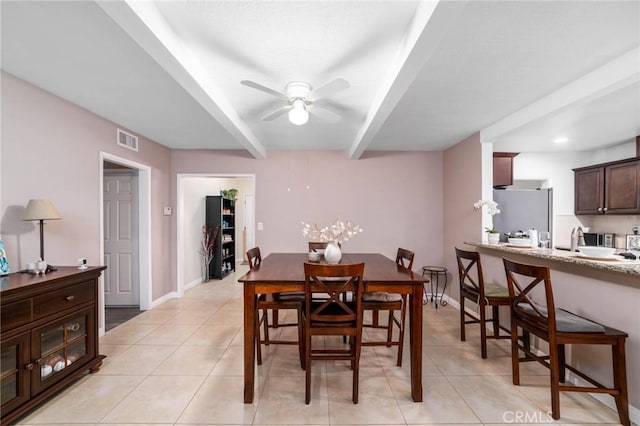 dining space with beamed ceiling, light tile patterned floors, visible vents, and ceiling fan