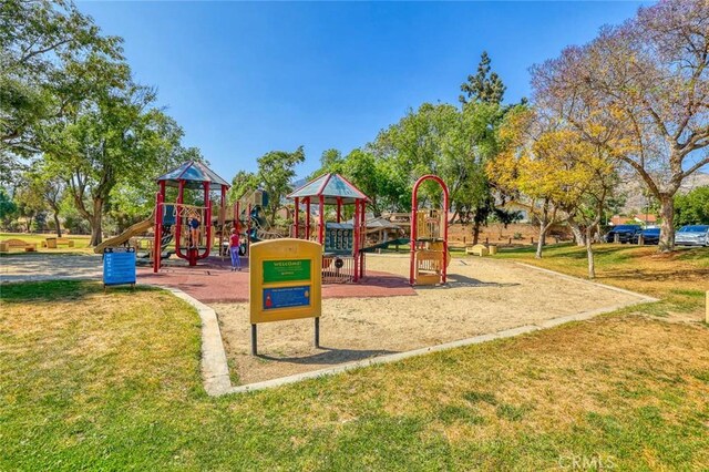 community jungle gym featuring a lawn