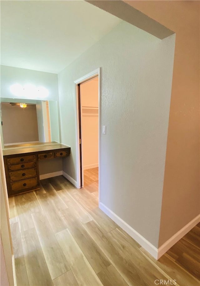 interior space with baseboards and light wood-style floors