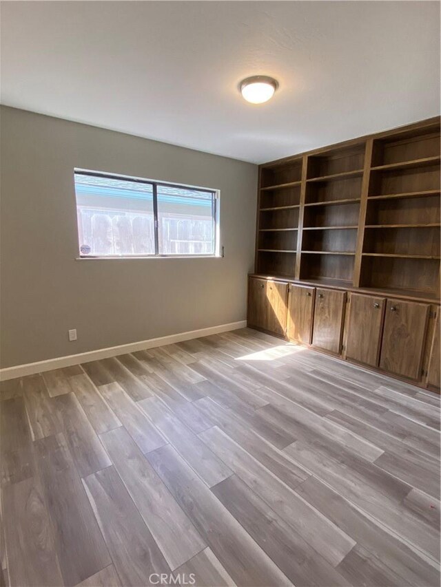 empty room featuring light wood-style floors and baseboards