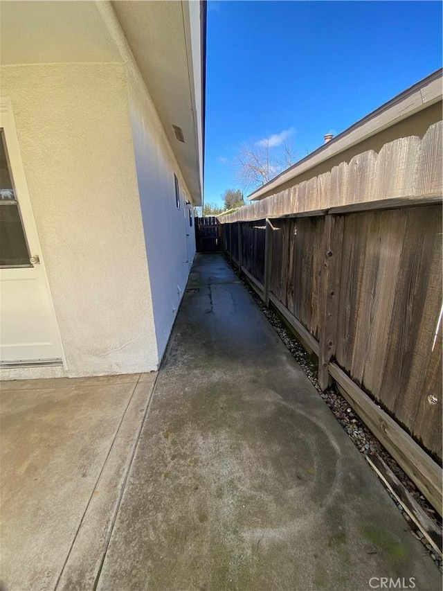 view of home's exterior with fence and stucco siding