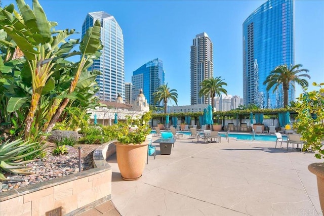 pool featuring a view of city and a patio