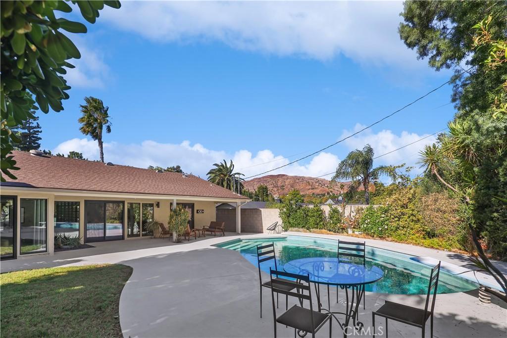 view of pool with a mountain view, fence, a patio area, and a fenced in pool