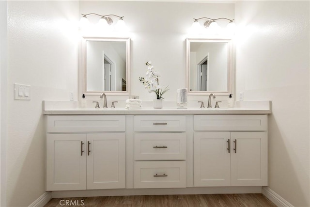 10 Windsong, Irvine, CA 92614 - bathroom featuring double vanity, baseboards, and wood finished floors