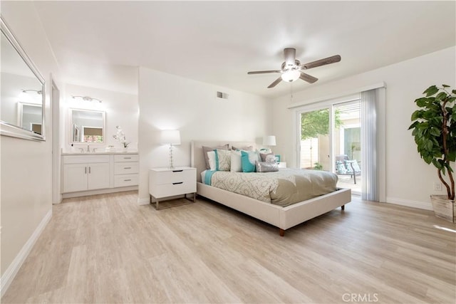 10 Windsong, Irvine, CA 92614 - bedroom featuring access to exterior, light wood-type flooring, a sink, and baseboards