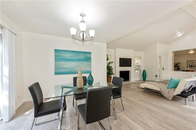 10 Windsong, Irvine, CA 92614 - dining space with a chandelier, light wood-style flooring, baseboards, a fireplace, and vaulted ceiling