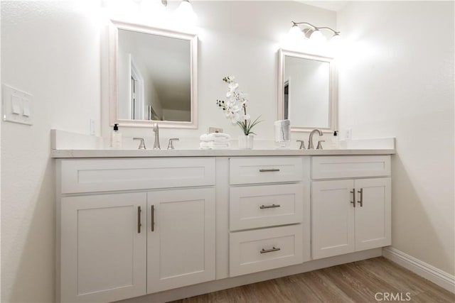 10 Windsong, Irvine, CA 92614 - full bathroom featuring double vanity, wood finished floors, and baseboards