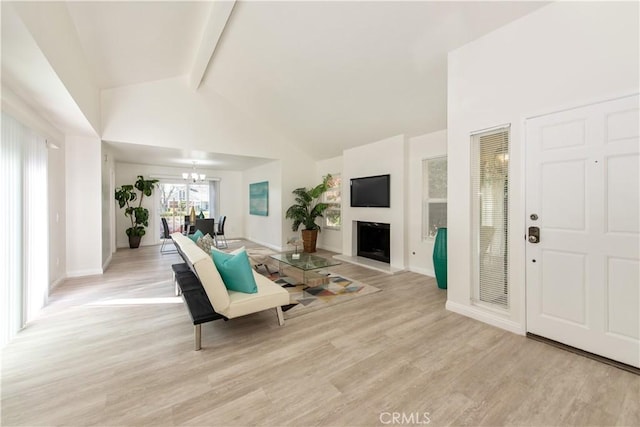 living room featuring beam ceiling, baseboards, high vaulted ceiling, light wood-style flooring, and a notable chandelier