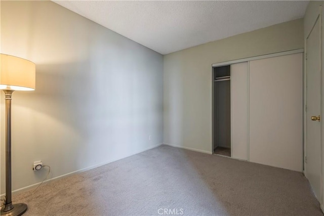 355 S Los Robles Ave Unit 310, Pasadena, CA 91101 - unfurnished bedroom featuring carpet, a closet, a textured ceiling, and baseboards