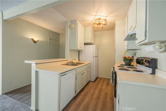 kitchen with white appliances, light countertops, under cabinet range hood, and a sink