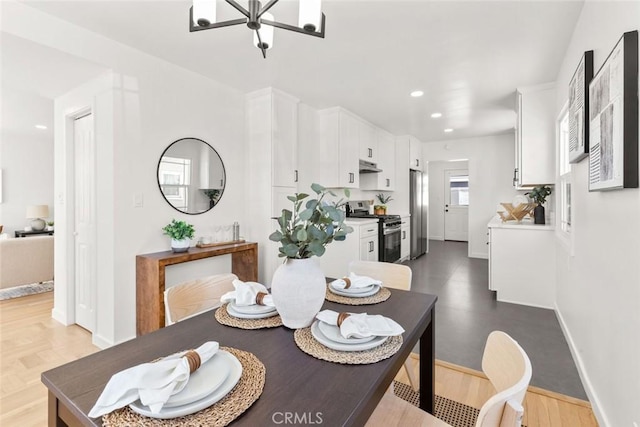 dining room with wood finished floors, a notable chandelier, recessed lighting, and baseboards