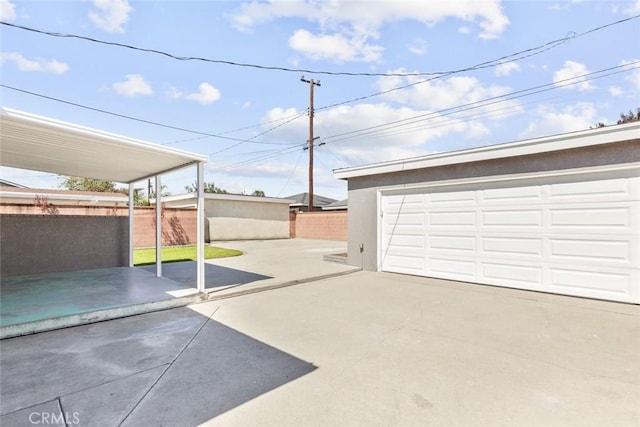 detached garage featuring fence