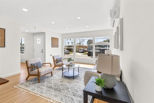 living area featuring recessed lighting, wood finished floors, and baseboards