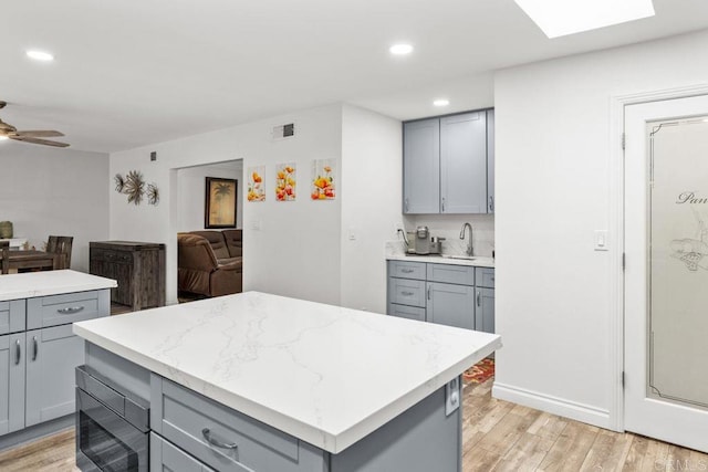 6756 Monte Verde Dr, San Diego, CA 92119 - kitchen featuring light wood-style flooring, visible vents, gray cabinets, and black microwave