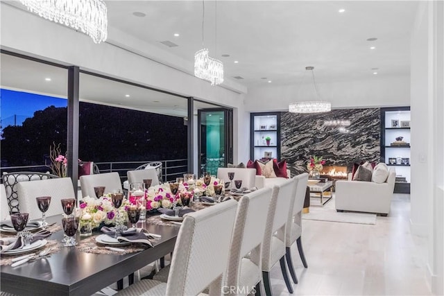 dining space with recessed lighting, wood finished floors, and a chandelier
