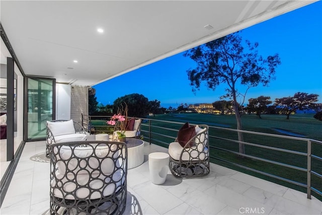 view of patio featuring outdoor dining area and a balcony