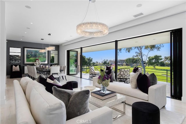 living area featuring a notable chandelier, recessed lighting, and visible vents