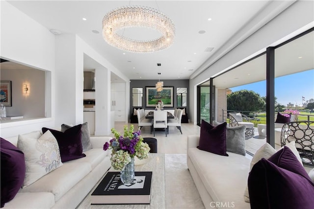 living area with recessed lighting and a notable chandelier