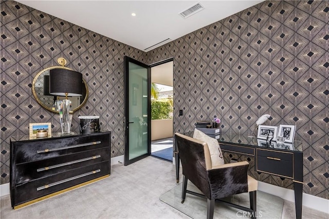 carpeted home office with visible vents, baseboards, and wallpapered walls