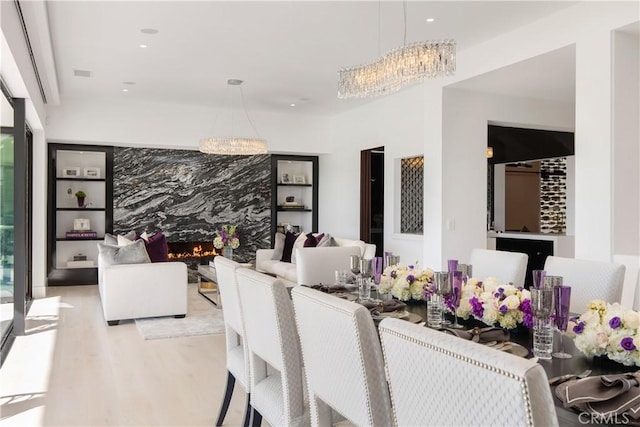 dining space featuring recessed lighting, visible vents, an inviting chandelier, and wood finished floors