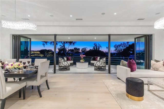 dining space with wood finished floors and visible vents