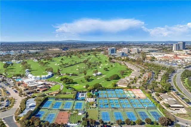 drone / aerial view featuring golf course view and a view of city