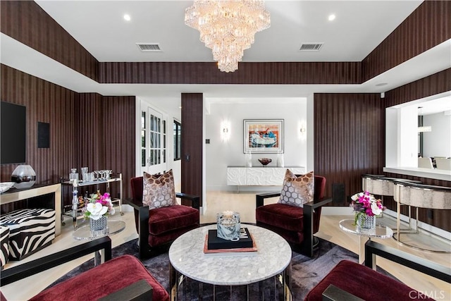 living area with visible vents, recessed lighting, and an inviting chandelier